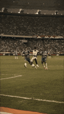 a soccer player is kicking a ball in front of a banner that says beijos blues e poesia