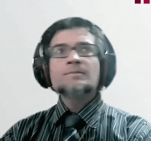 a man wearing glasses and headphones is looking at the camera