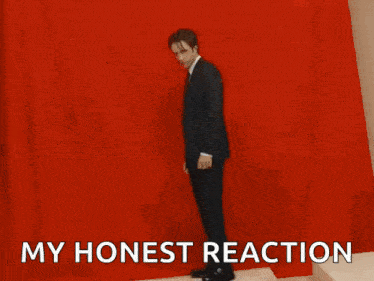a man in a suit and tie has his hands folded in prayer and the words " my honest reaction " above him
