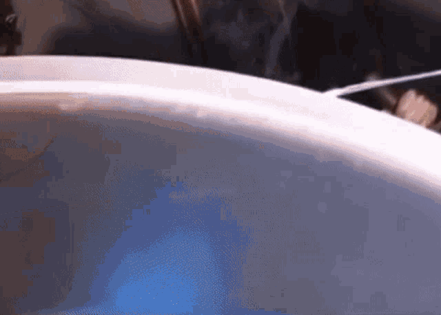 a close up of a white object with a blue light in the background