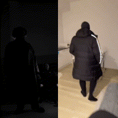 a silhouette of a person standing in a dark room next to a silhouette of a person walking down stairs