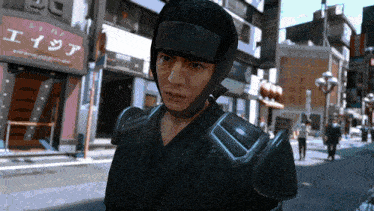 a man wearing a helmet and armor stands in front of a building that says エイシア