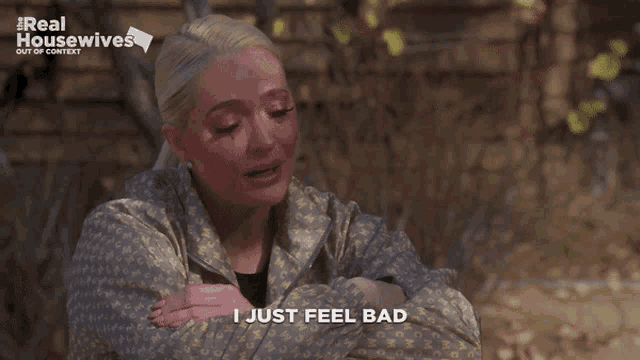 a woman says " i just feel bad " in front of a sign that says real housewives