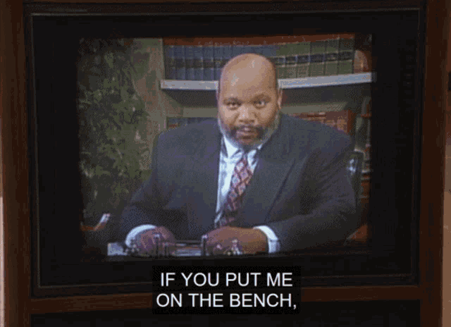 a tv screen shows a man in a suit and tie talking about crime