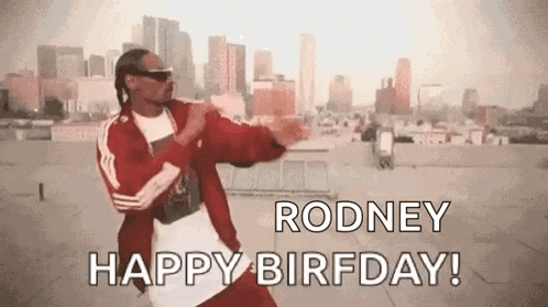 snoop dogg is dancing on a rooftop in front of a city .