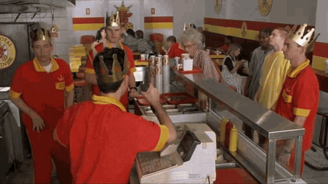 a man wearing a crown stands in front of a sign that says royal diner