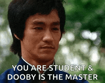 bruce lee is making a funny face with the words you are student and dooby is the master .