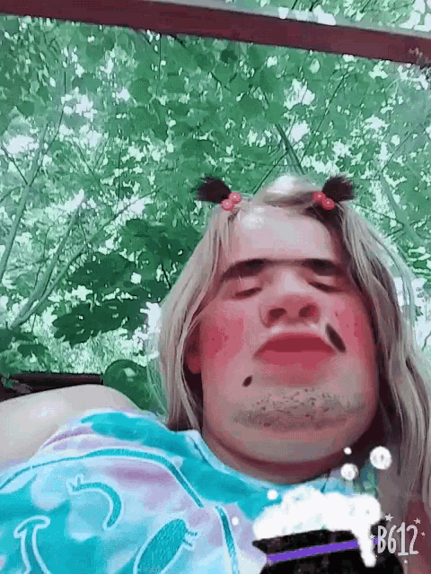 a woman with pigtails and a fake mustache is taking a selfie with b612