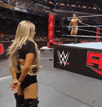 a woman in a wrestling ring with a w on the side of the ring