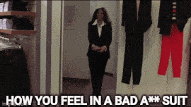 a woman in a suit is standing in a hallway with the words how you feel in a bad a *** suit