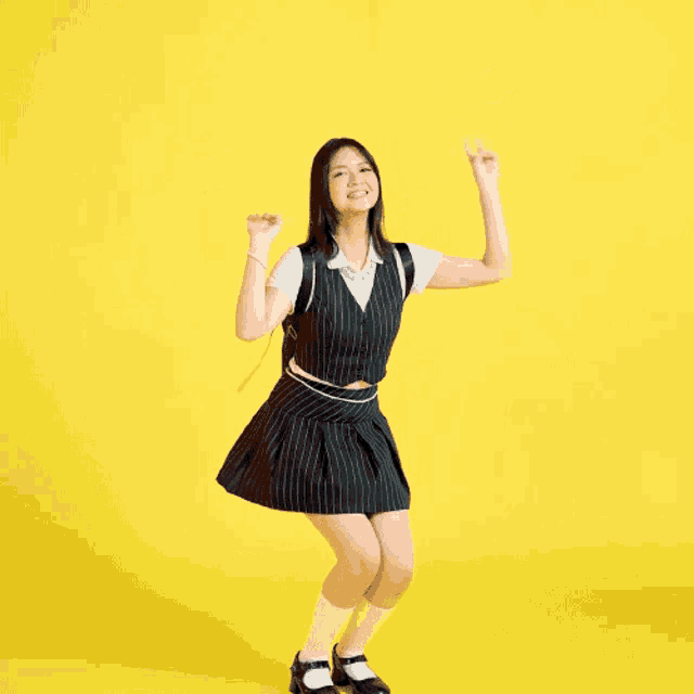 a woman in a striped vest and skirt is dancing