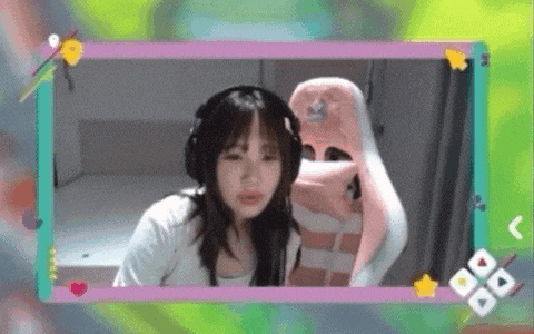 a girl wearing headphones and a pink chair is sitting in a frame .