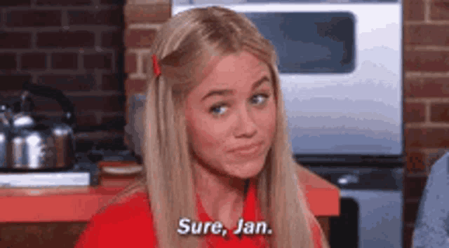 a blonde woman is talking to a man in a kitchen and saying `` sure , jan '' .