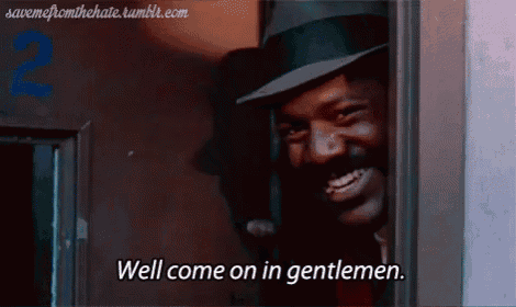 a man in a fedora is smiling and says well come on in gentlemen