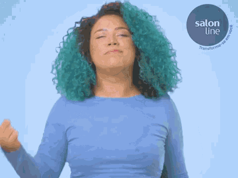 a woman with blue hair is wearing a blue shirt and a salon line logo