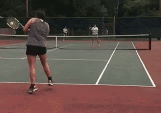 a woman is playing tennis on a court