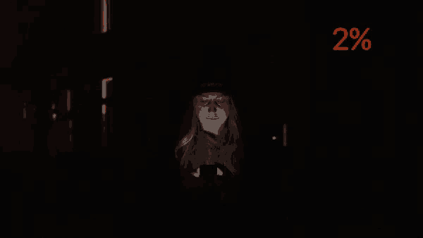 a woman is looking at her phone in the dark with a percentage of 2%