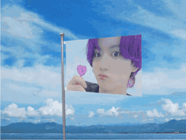 a flag with a picture of a girl with purple hair holding a pink heart