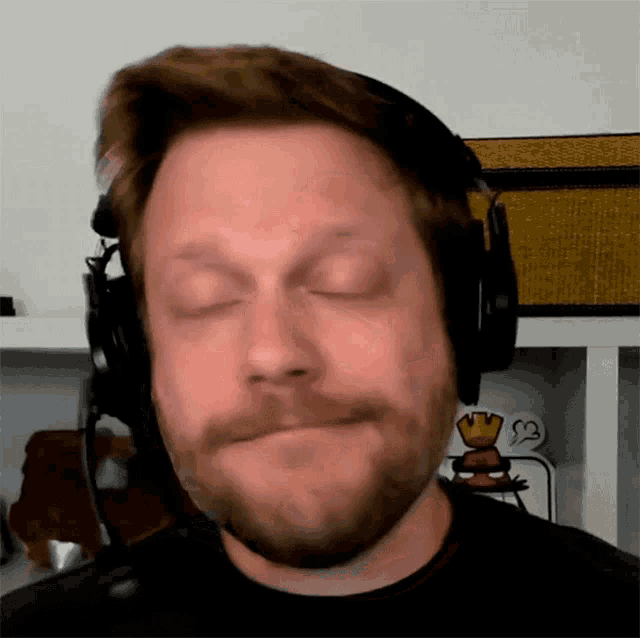 a man with a beard wearing headphones and a microphone