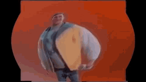 a man in a colorful jacket and a t-shirt is standing in front of an orange background .