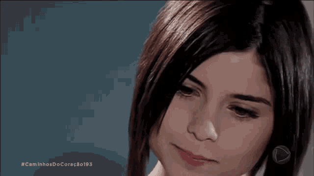 a close up of a woman 's face with the words caminhos do coração 103 on the bottom