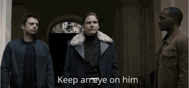 two men standing next to each other with the words keep an eye on him