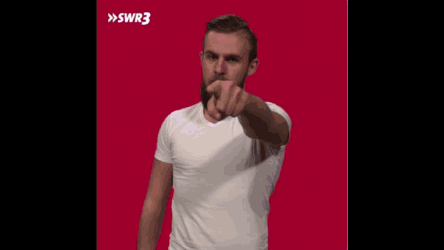 a man with a beard is wearing a white t-shirt with swr3 on the bottom right