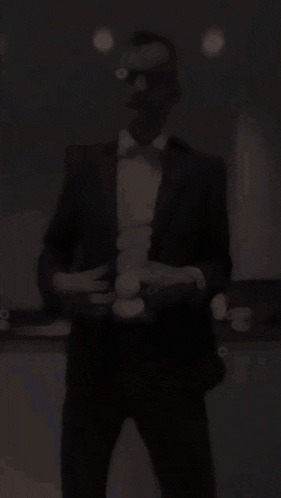 a man in a suit and headphones is dancing
