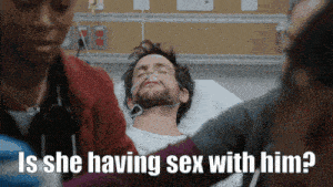 a man in a hospital bed with a nurse asking if he is having sex with him