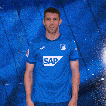 a man wearing a blue shirt with the word sap on the front