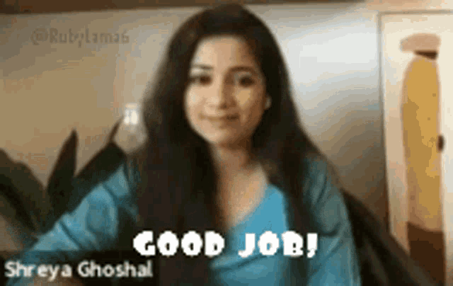 a woman in a blue shirt says good job to the camera