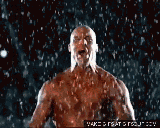a bald man is standing in the rain with his mouth open .