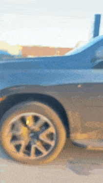 a close up of a black car 's wheel and tire