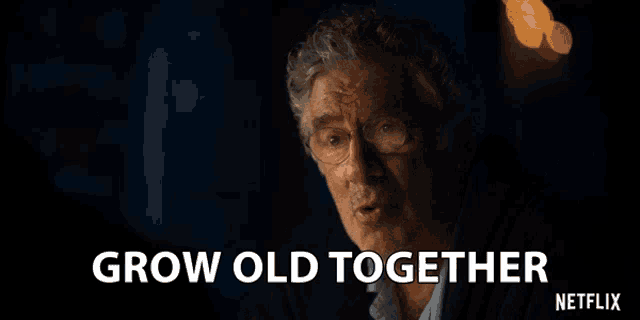 a man with glasses and the words grow old together