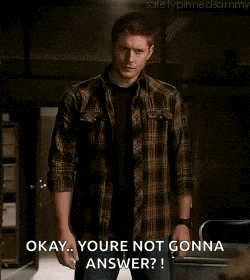 a man in a plaid shirt is standing with his arms crossed and saying okay . you 're not gonna answer