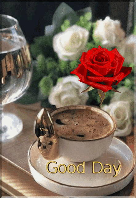 a cup of coffee on a saucer with a red rose and the words good day