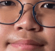 a close up of a person 's face with glasses on .