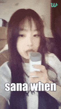 a girl with long hair is holding a microphone and the words sana when are on the screen