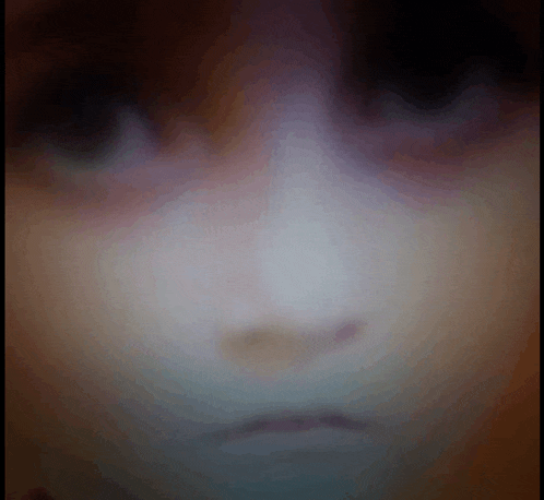a blurred image of a person 's face with a purple background