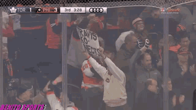 a man holding a sign that says travis ko nects