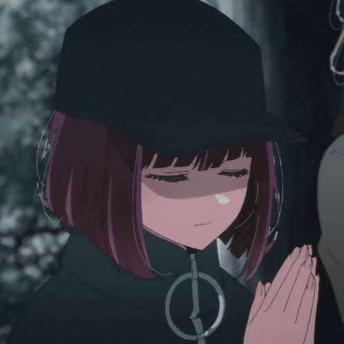 a girl wearing a black hat and a jacket with a clock on it