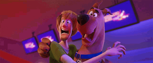 scooby doo and a man are standing next to each other