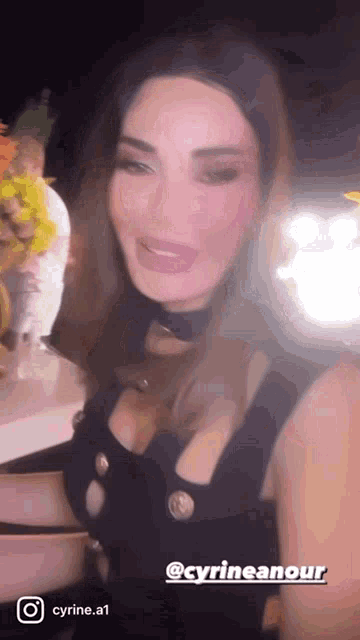 a woman in a black dress with the name cyrineanour on it