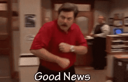 a man in a red shirt is dancing in an office with the words `` good news '' written below him .