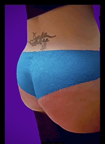 a woman with a tattoo on her back is wearing a blue underwear