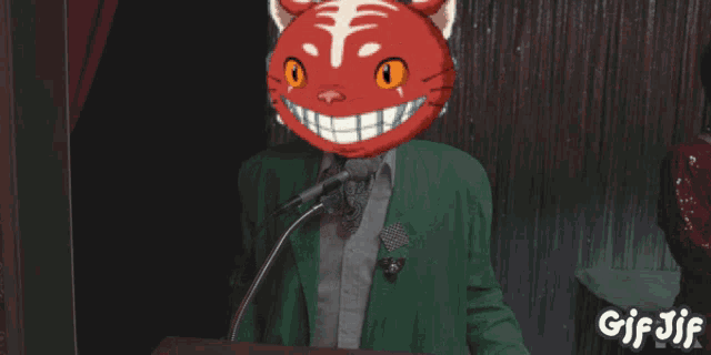 a man with a red cat on his head speaking into a microphone with the words goodnight written above him