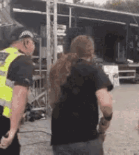 two men are standing next to each other in front of a stage .