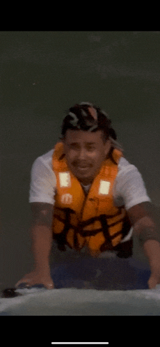 a man wearing a life vest is riding a jet ski