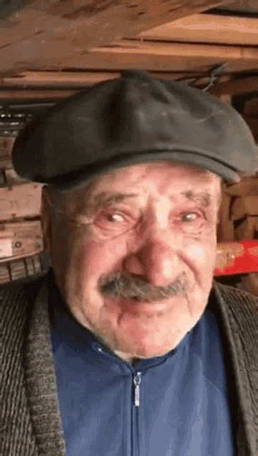 a man with a mustache wearing a hat and a jacket
