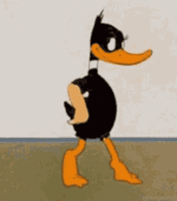 a cartoon duck standing next to a wall